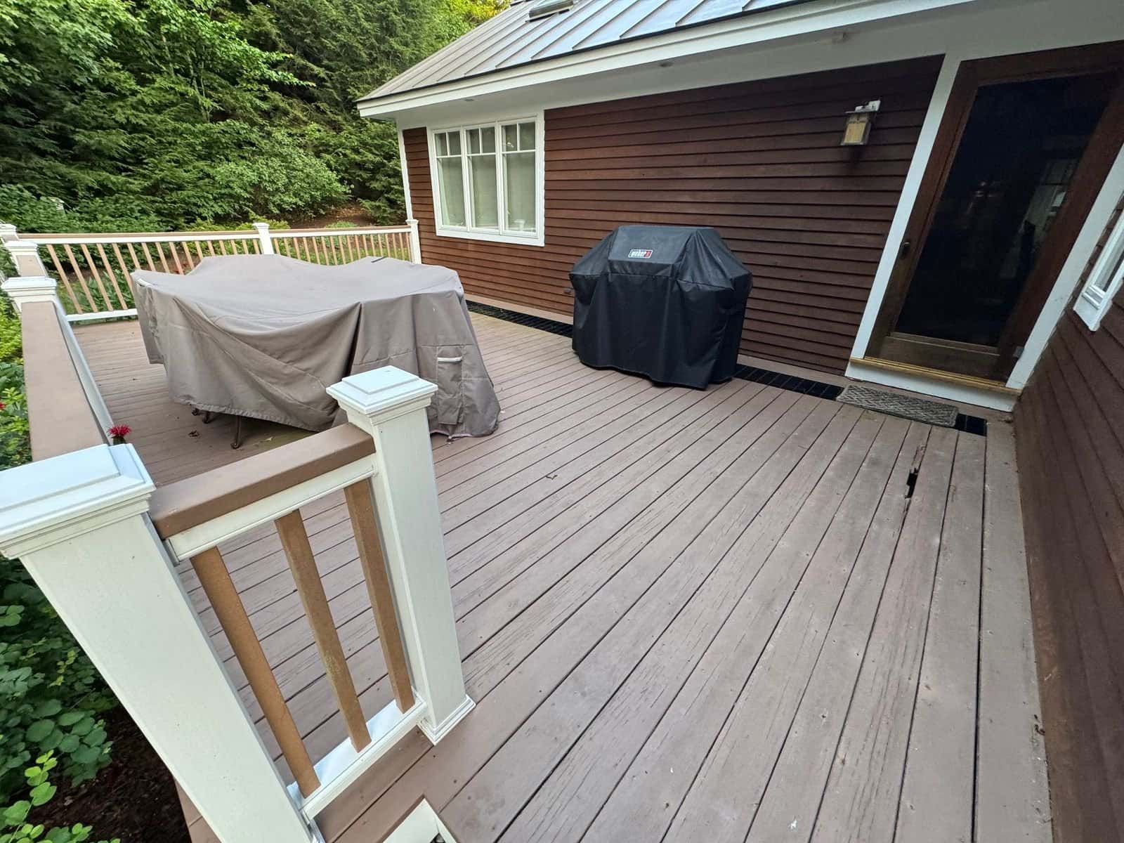 Customer photo of the deck and railing from the side yard before removal