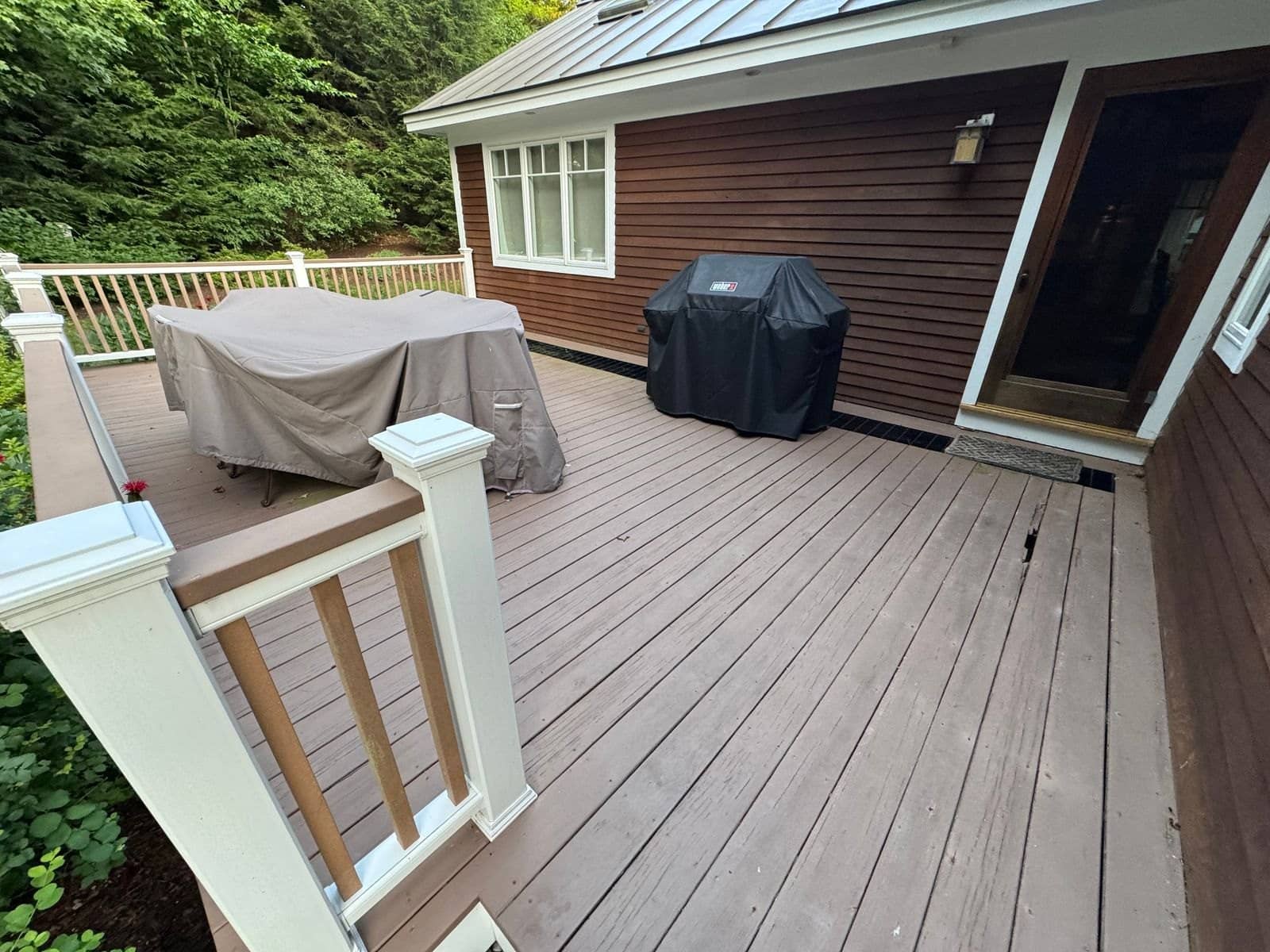 Customer photo of the deck and railing from the side yard before removal