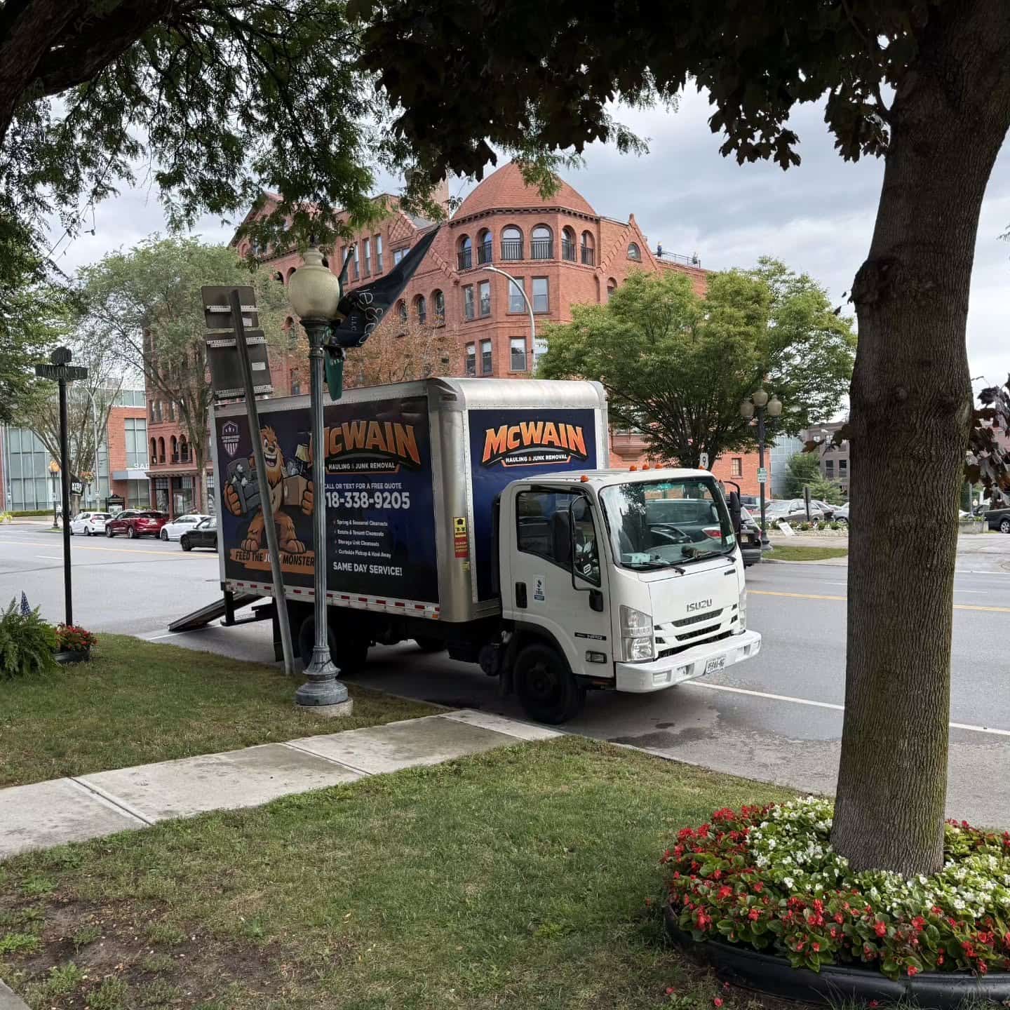McWain Hauling box truck with the Junk Monster wrap parked on Broadway in downtown Saratoga Springs
